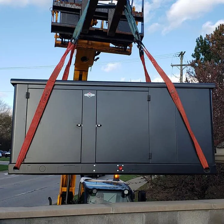 Powerhouse Generator -a crane lifting a large black generator