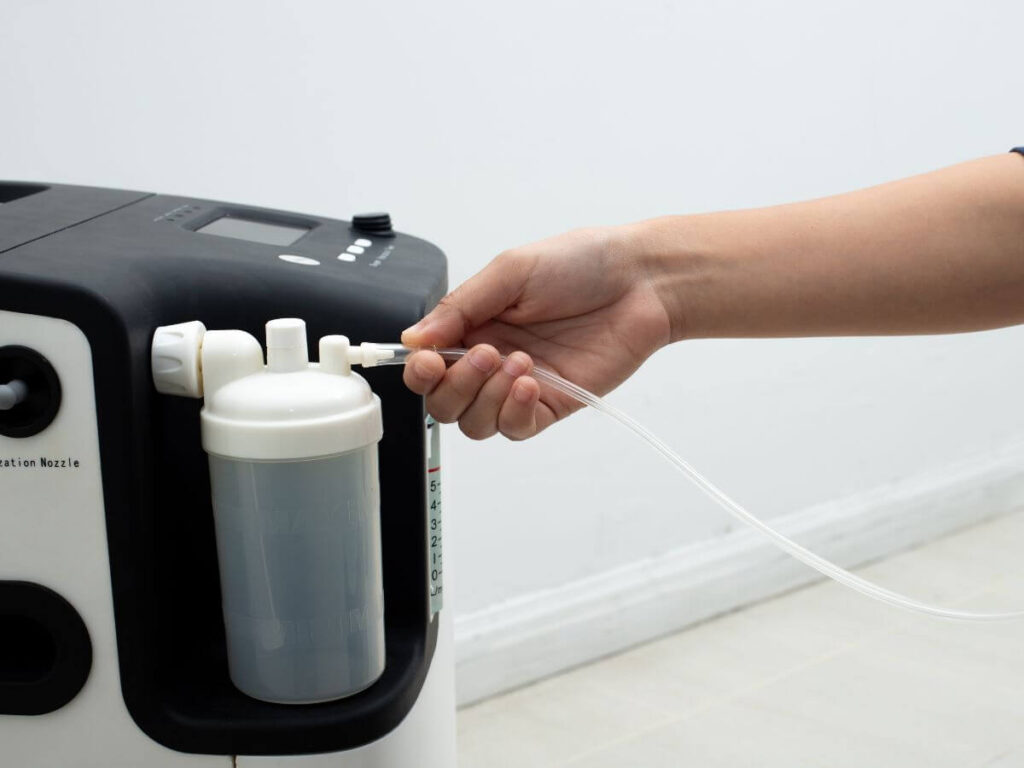 Close-up of a home oxygen concentrator, showing the risks families face during outages without a whole-house generator in Southeast Michigan.